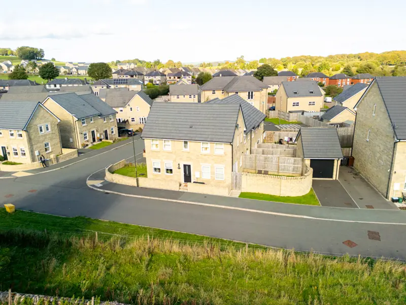 Aerial view of the cottage and street