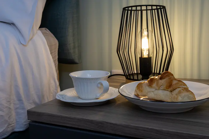 Bedside lamp and a croissant