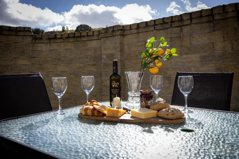 Patio table with stone wall behind