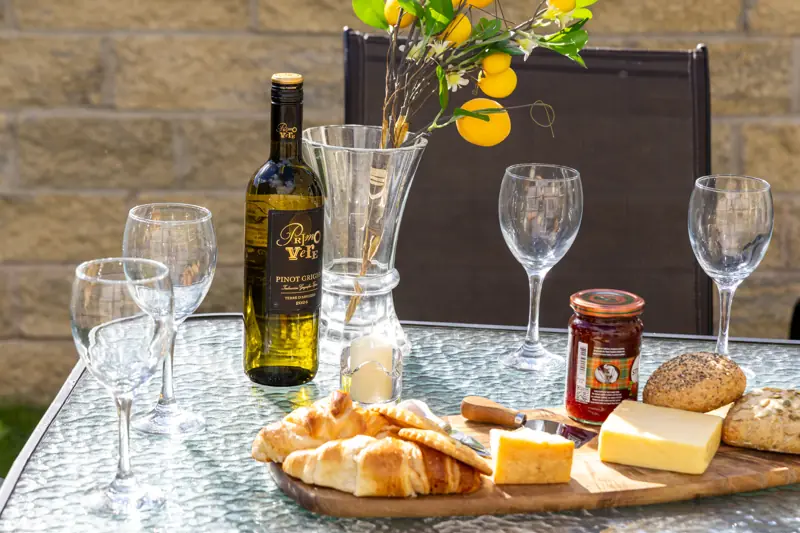 Cheese board and wine on the garden table