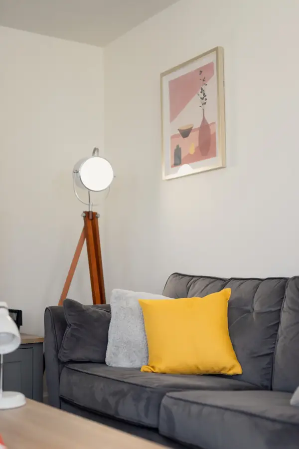 Corner of the sitting room with a tripod lamp