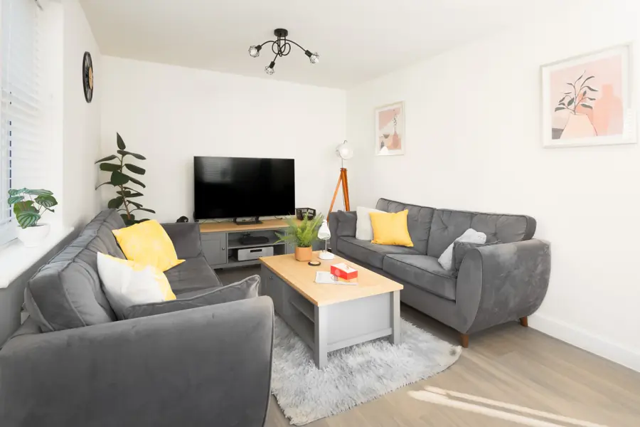 Sitting room with three sofas and a Smart TV