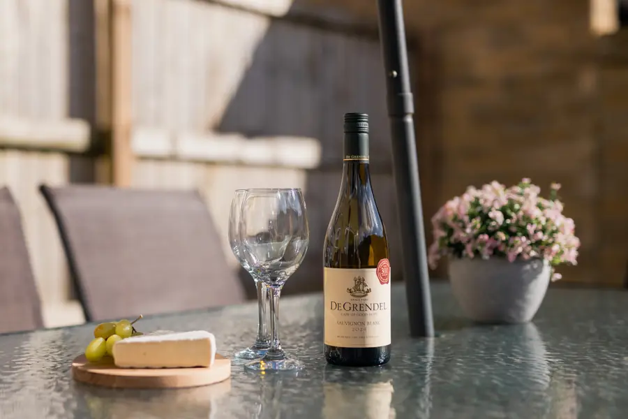 Cheese board and wine on the patio table